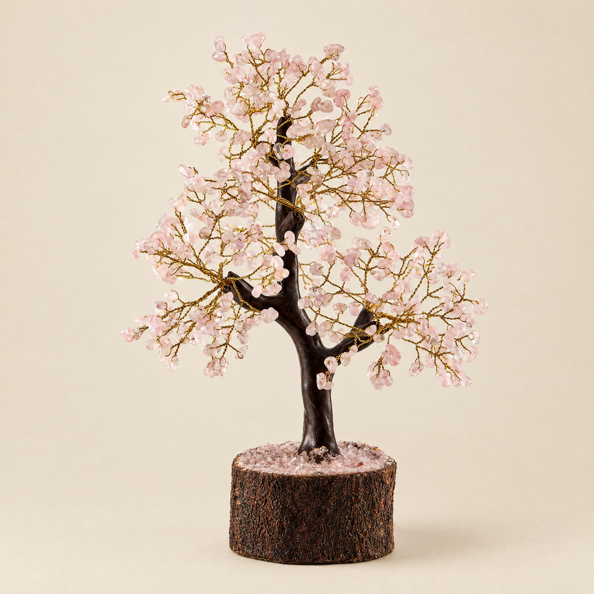 Rose quartz crystal tree with gold-tone wire, front view