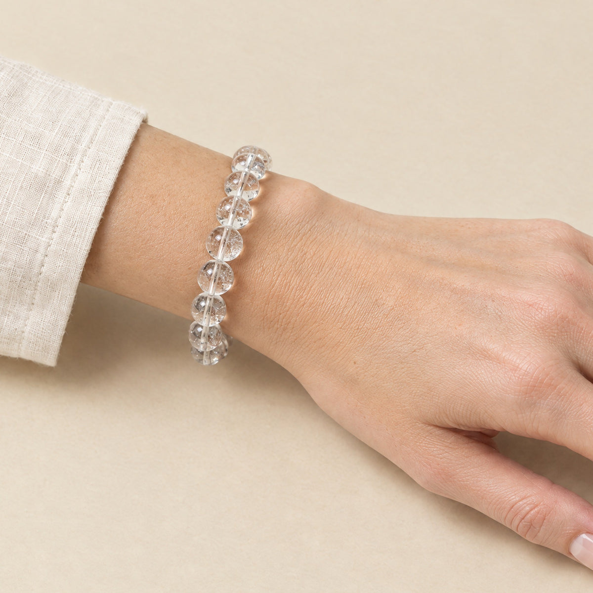 Clear quartz crystal bracelet worn on a woman's wrist