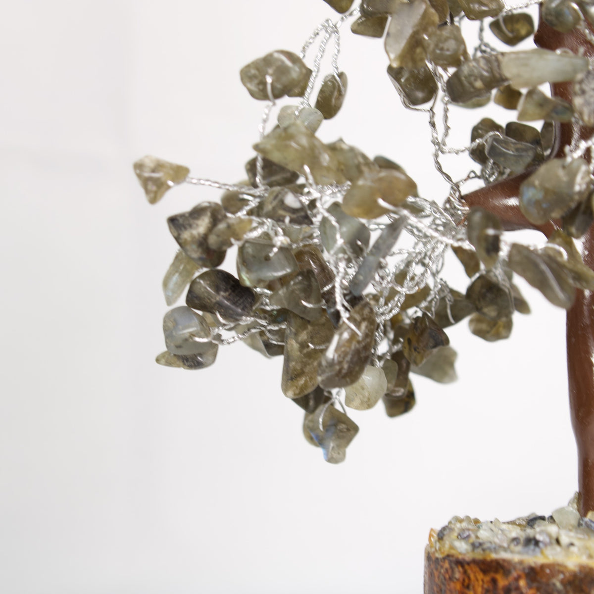 Close-up of grey-green labradorite chips on silver-tone wire branches