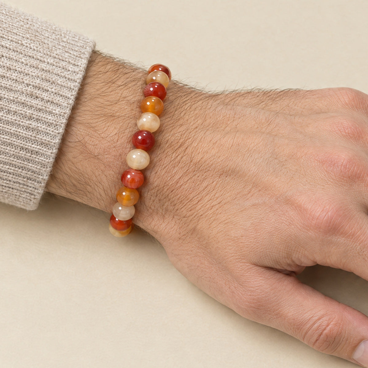 Carnelian bracelet worn on a man's wrist