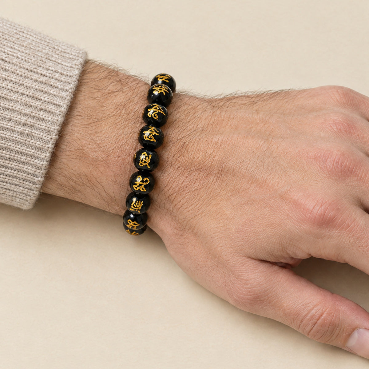 Om Mani Padme Hum bracelet worn on a man's wrist