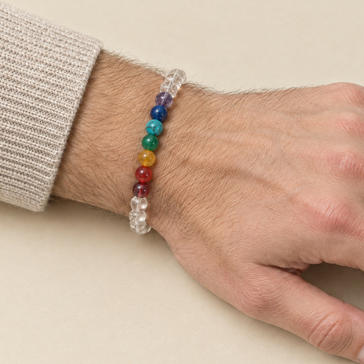 7 chakra and crystal bracelet worn on a man's wrist