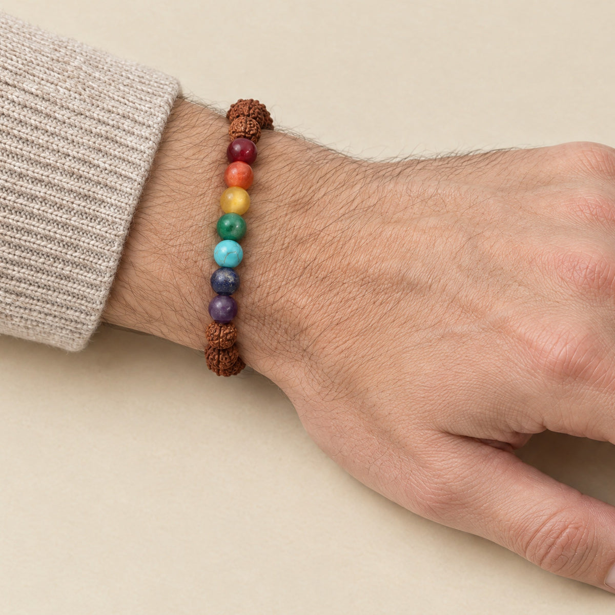 7 chakra and rudraksha bracelet worn on a man's wrist