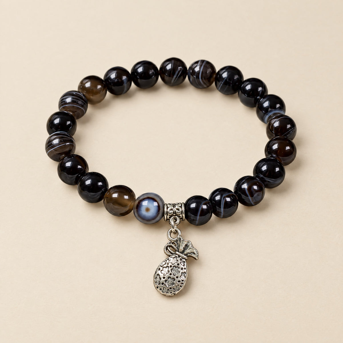 Money Bag Bracelet: 8 mm Sulemani agate beads with a silver-tone money bag charm
