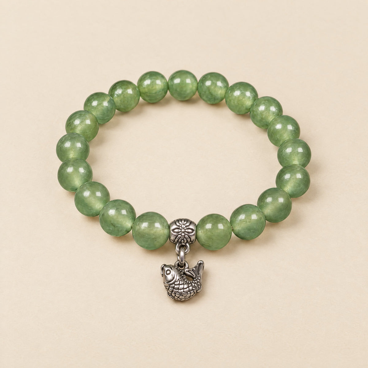 Lucky Koi Fish Bracelet: 8 mm light green onyx beads with a silver-tone koi fish charm