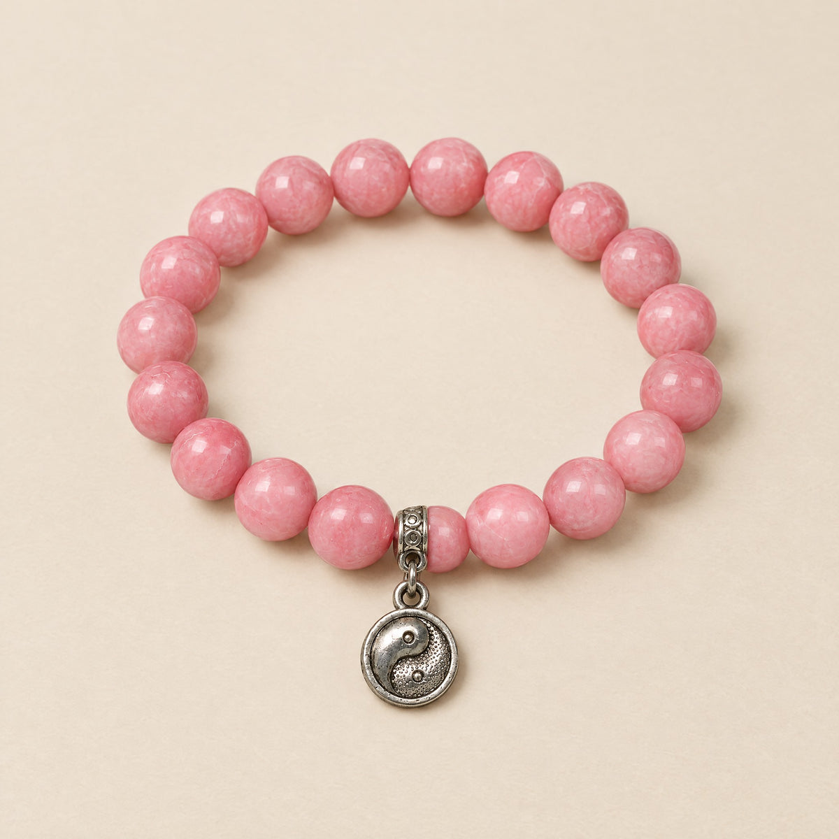 Yin Yang Bracelet: 8 mm pink onyx beads with a silver-tone yin yang charm