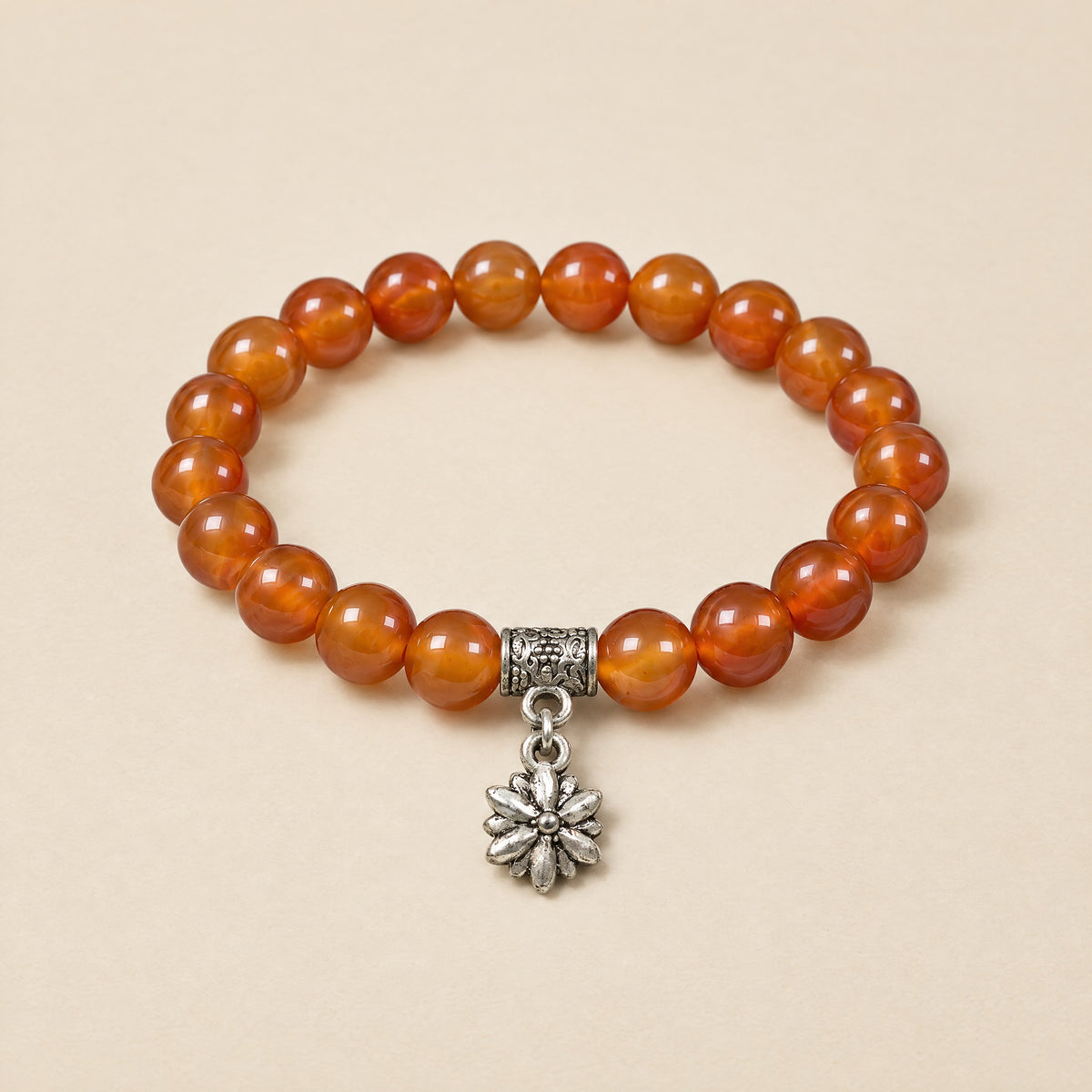 Flower Charm Bracelet: 8 mm carnelian beads with a silver-tone flower charm
