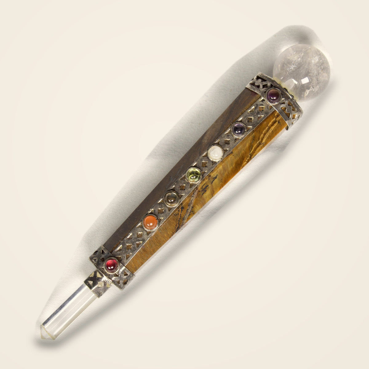 Tiger eye chakra wand at an angle showing the quartz point and crystal ball