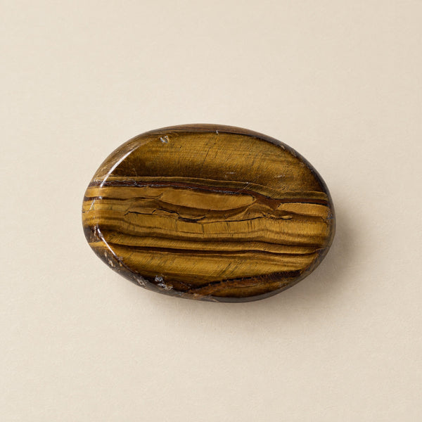 Polished tiger eye worry stone with thumb dip