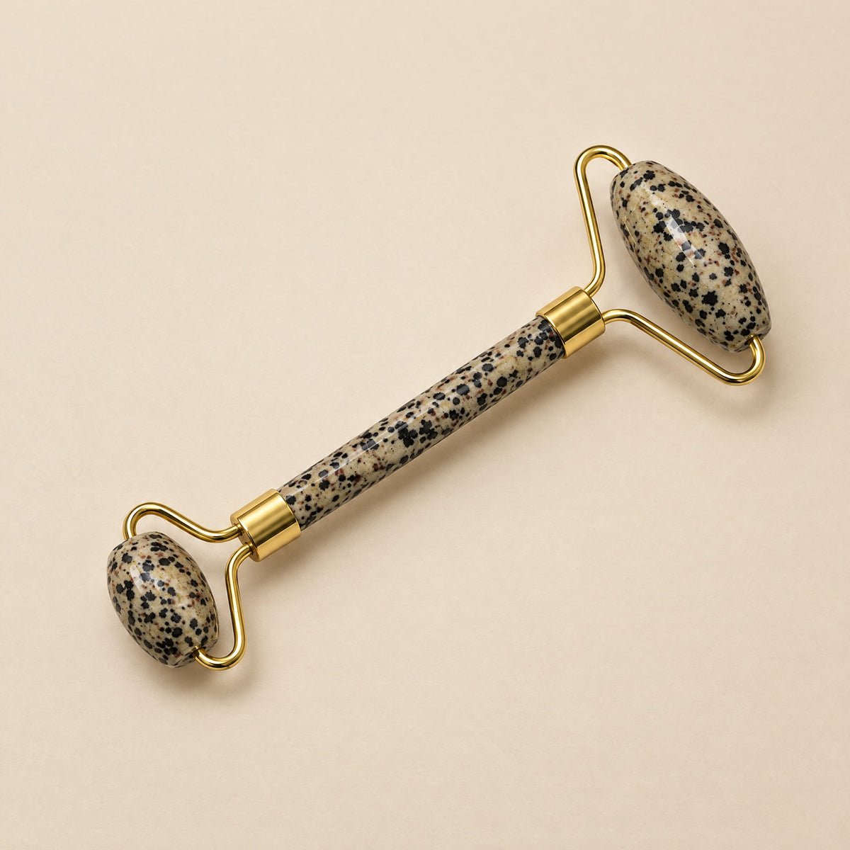 Dalmatian jasper face roller with gold-tone frame
