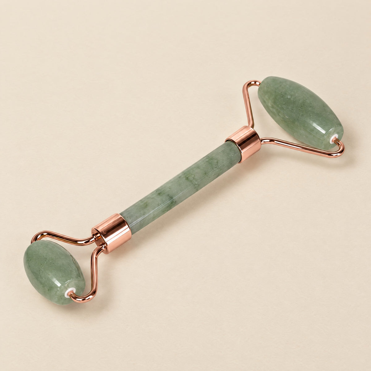 Light green jade face roller with a rose-gold-tone frame