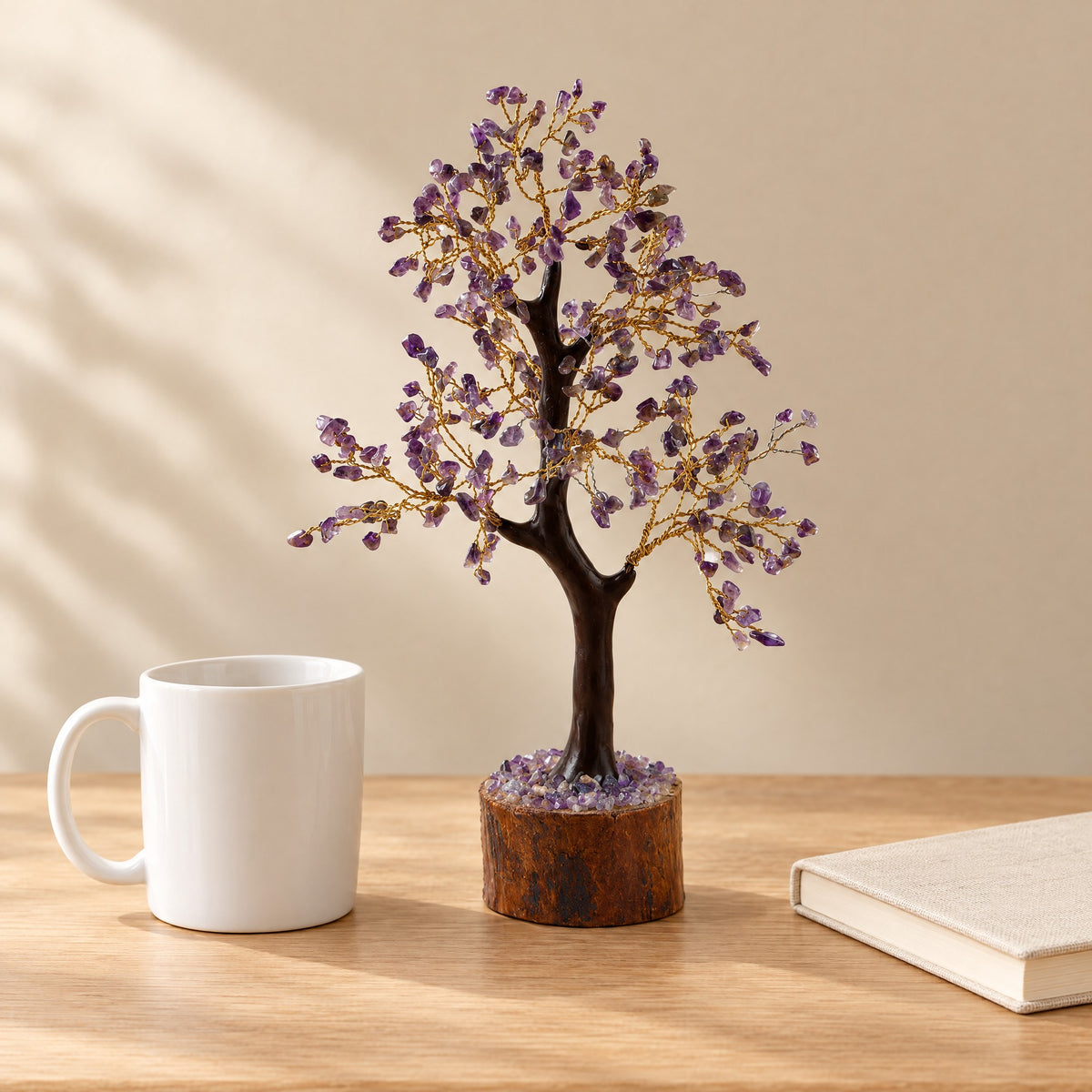 Amethyst crystal tree, 300 chips, on a desk beside a coffee mug for size