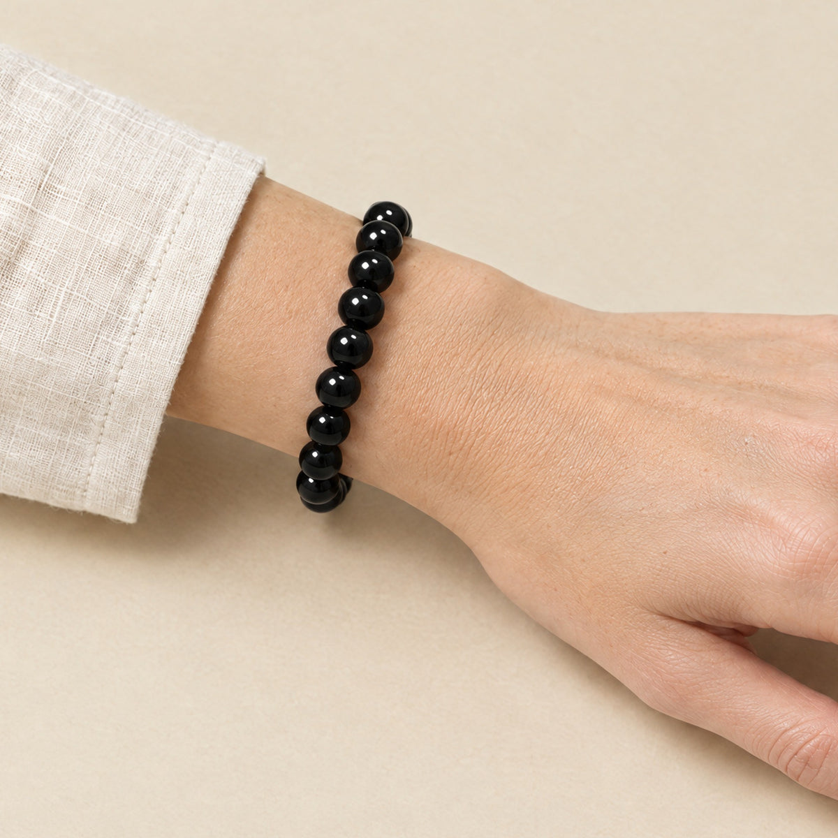 Black onyx bracelet worn on a woman's wrist