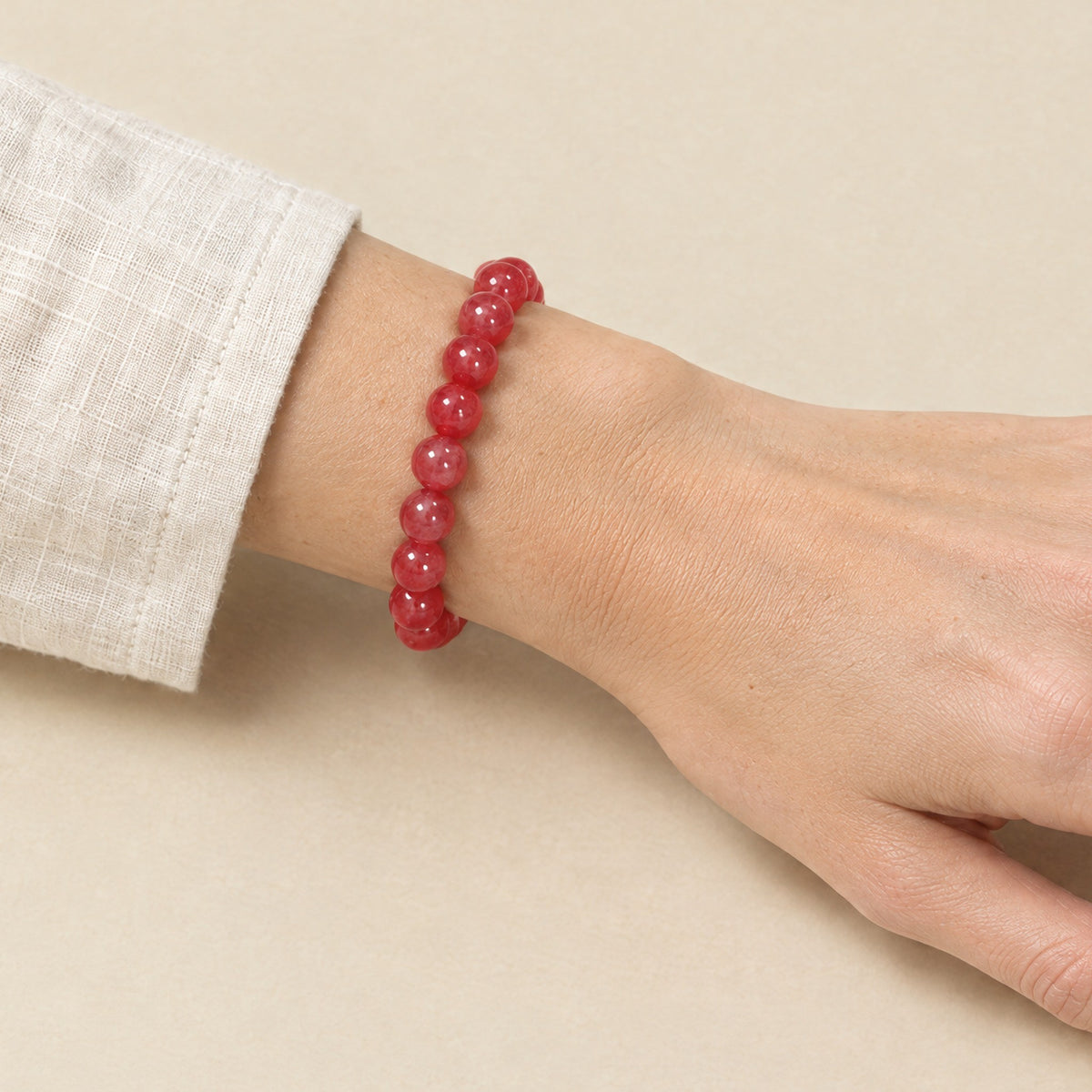 Cherry red onyx bracelet worn on a woman's wrist