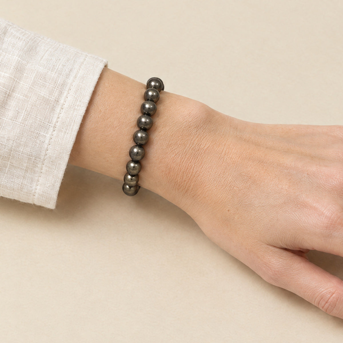 Pyrite bracelet worn on a woman's wrist