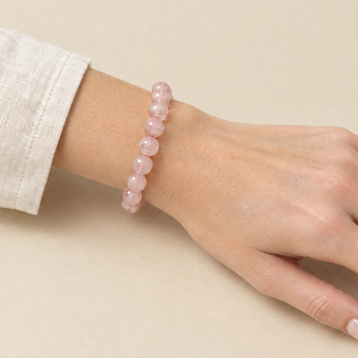 Rose quartz bracelet worn on a woman's wrist