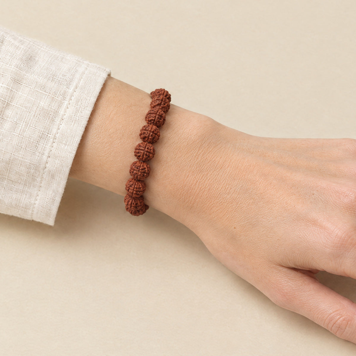 Rudraksha bracelet worn on a woman's wrist