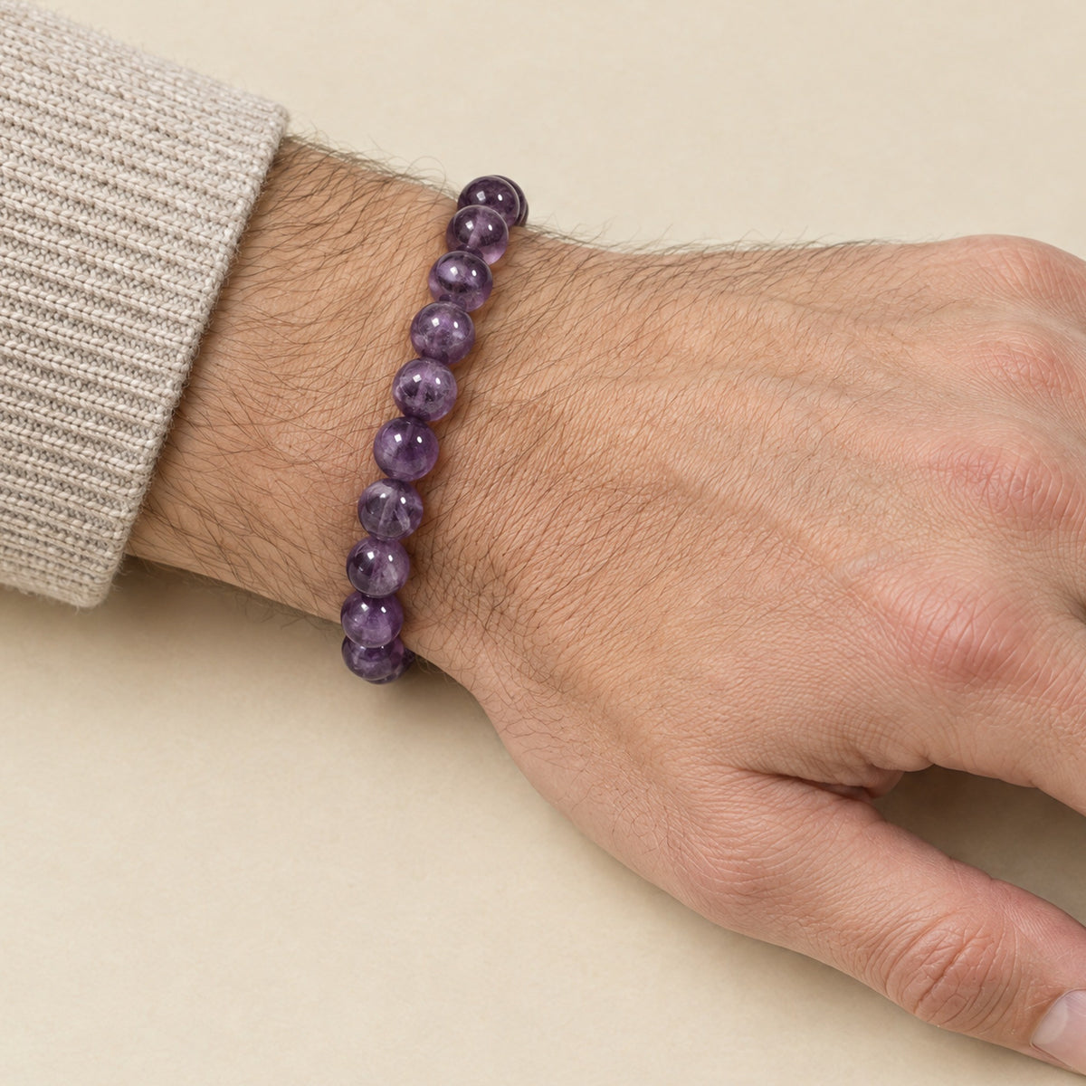 Amethyst bracelet worn on a man's wrist