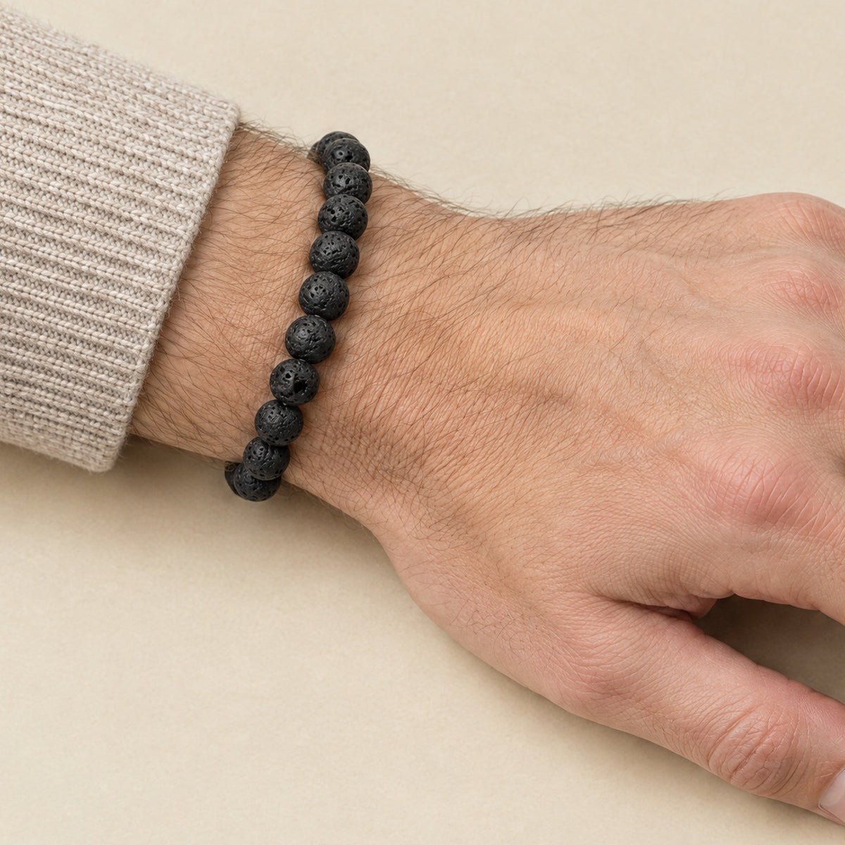 Black lava stone bracelet worn on a man's wrist