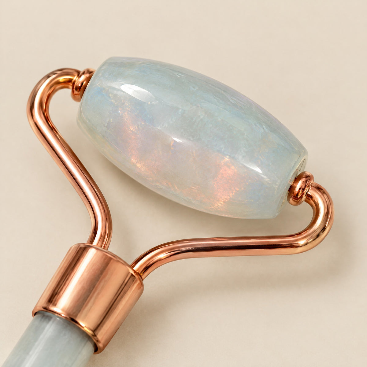 Close-up of the milky opal roller stone in a rose-gold-tone frame