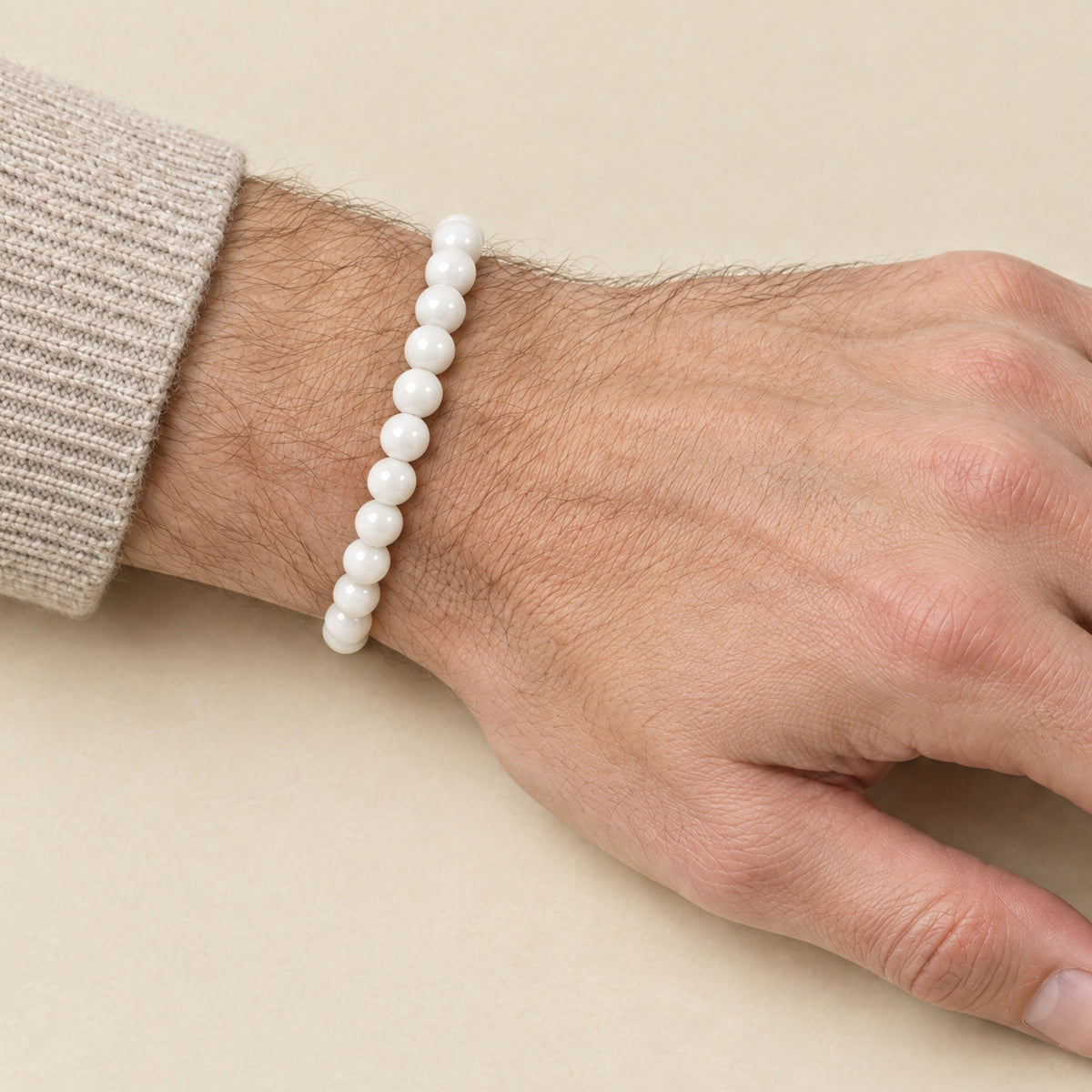 White onyx bracelet worn on a man's wrist