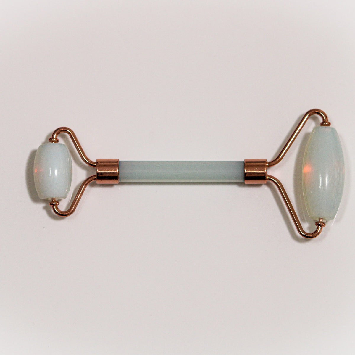 Unedited photo of the opal face roller with rose-gold-tone frame