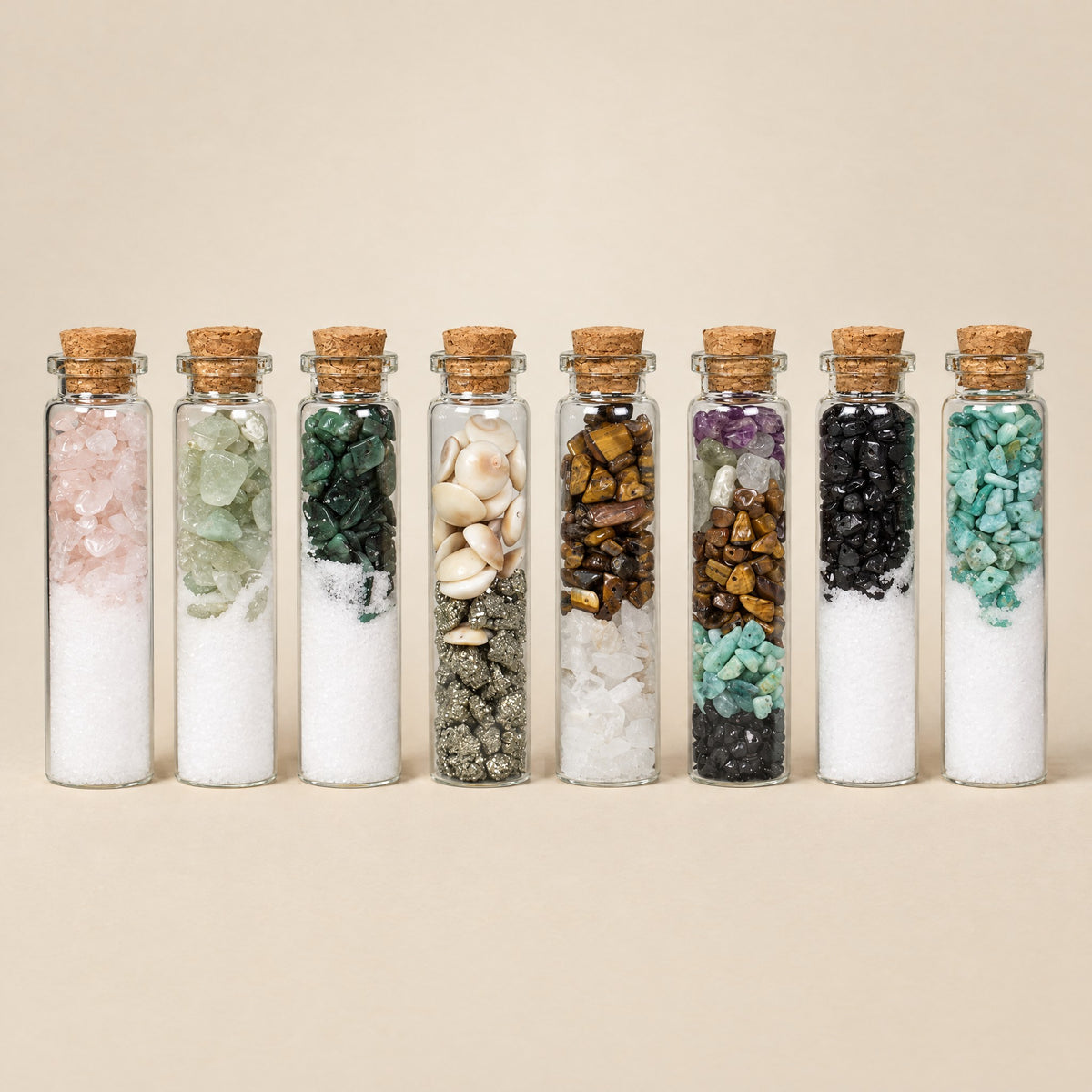 Eight crystal intention jars in a row, each with different crystals