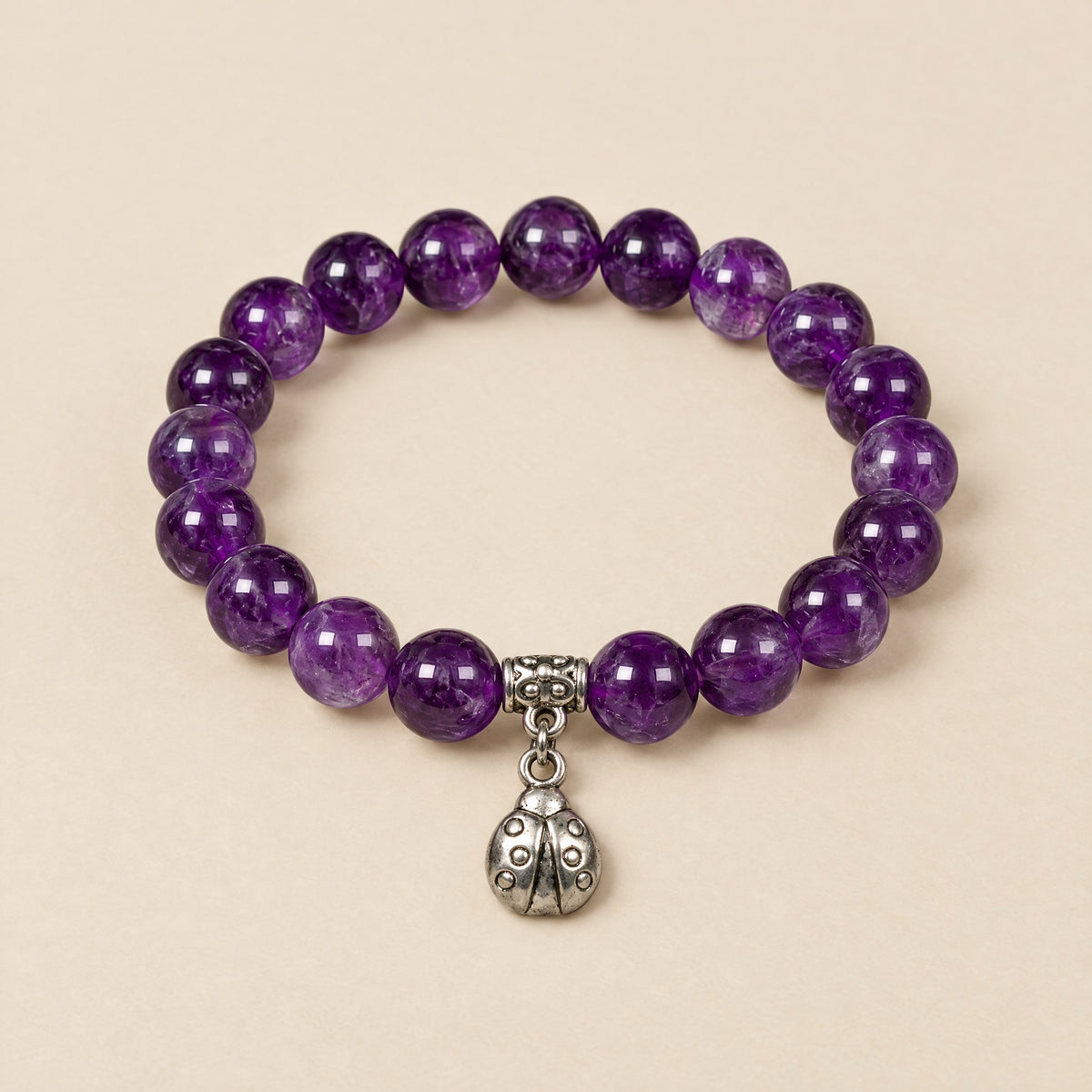 Lucky Ladybug Bracelet: 8 mm amethyst beads with a silver-tone ladybug charm