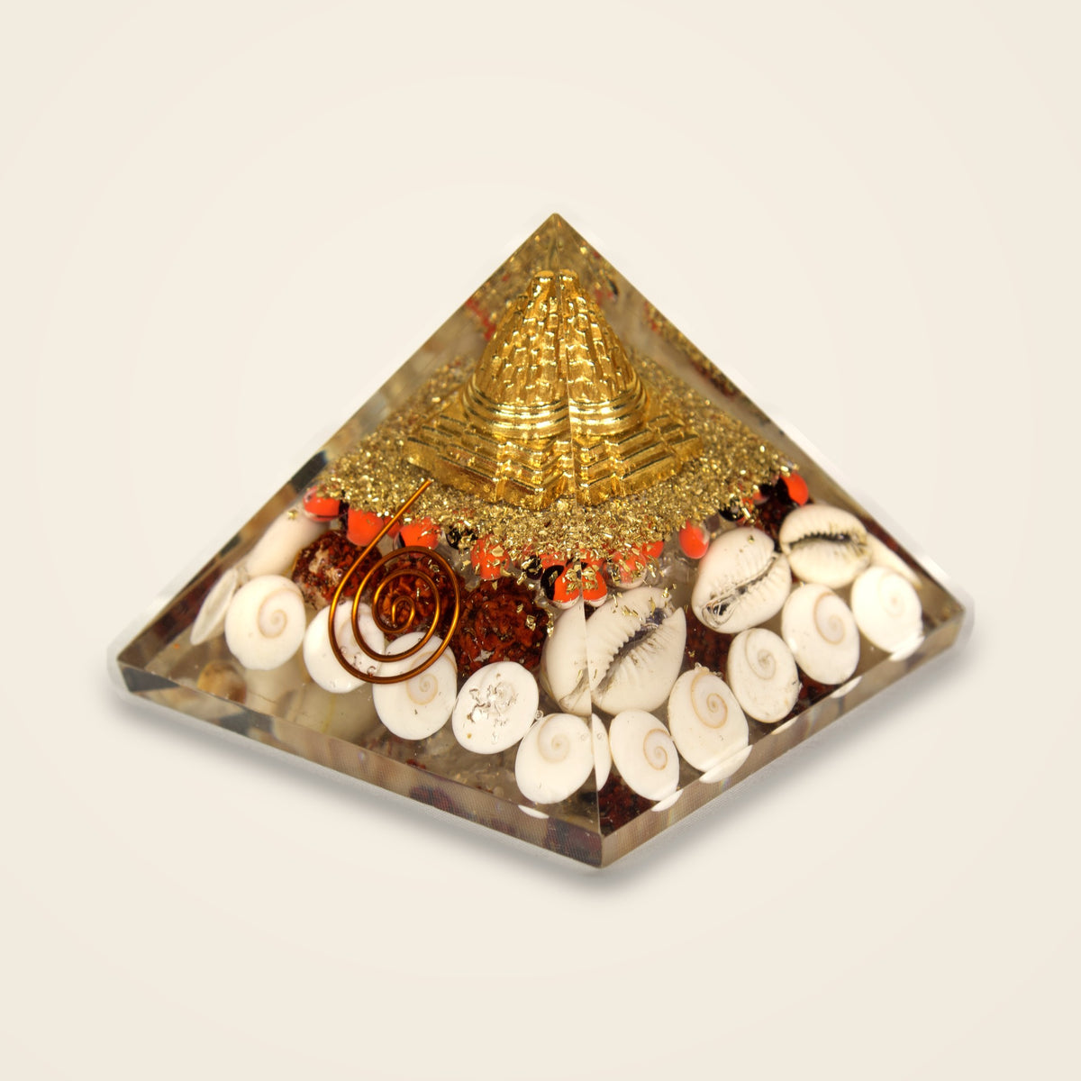 Shree Yantra wealth pyramid from above showing the gold-tone yantra and shells