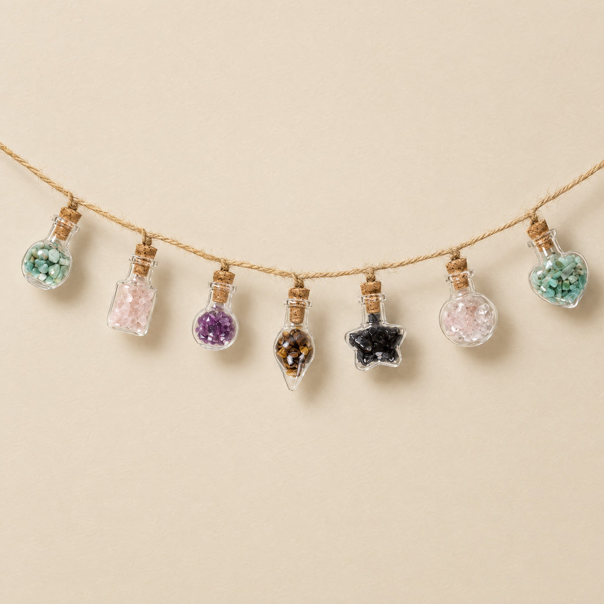 Wish bottle garland with seven mini gemstone bottles on jute twine