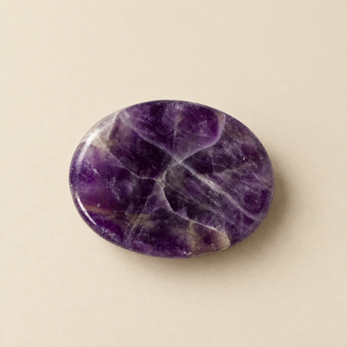 Polished amethyst worry stone with thumb dip