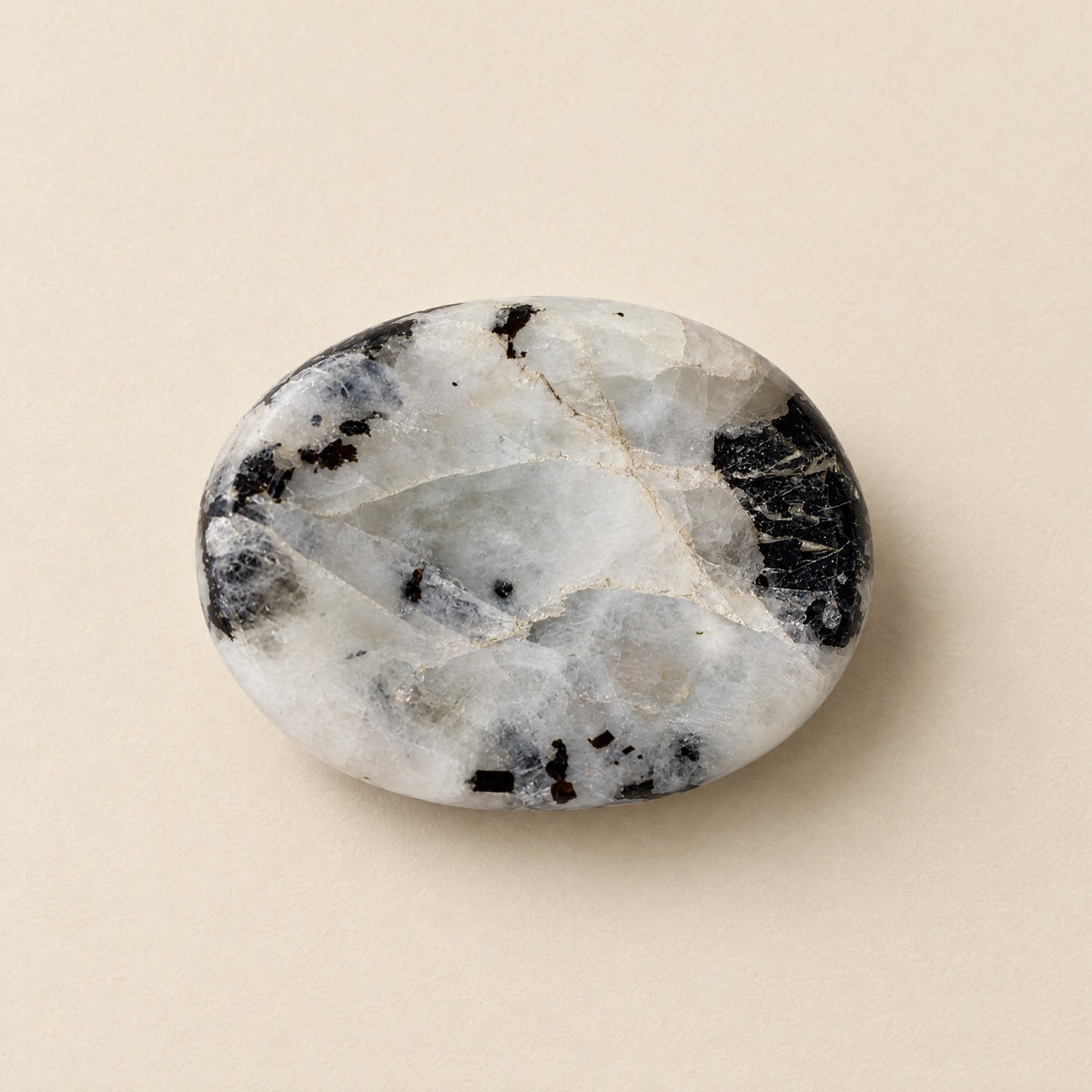 Polished white moonstone worry stone with thumb dip
