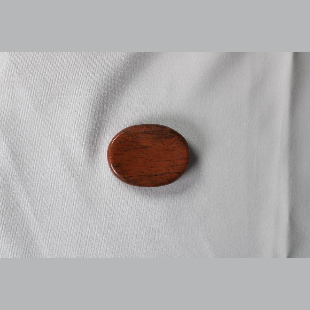 Unedited photo of the red jasper worry stone