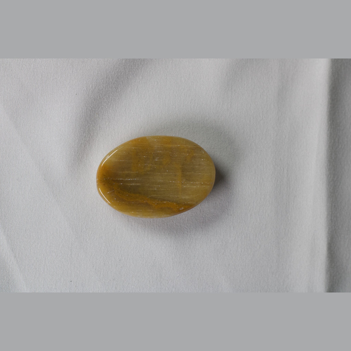 Unedited photo of the yellow aragonite worry stone