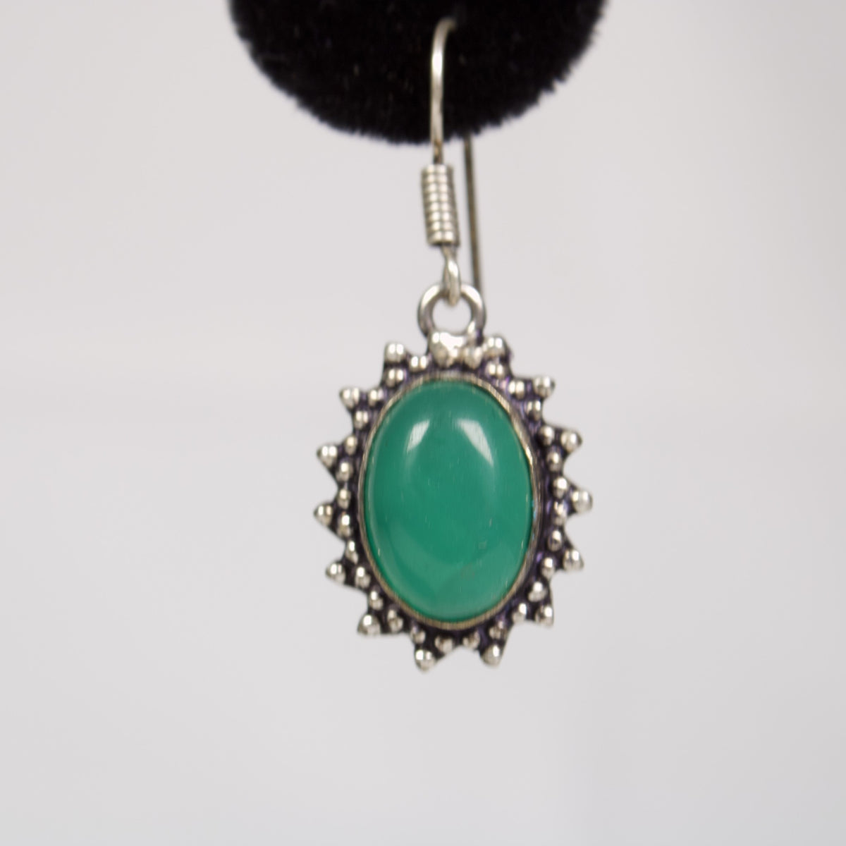 Close-up of one green onyx drop earring