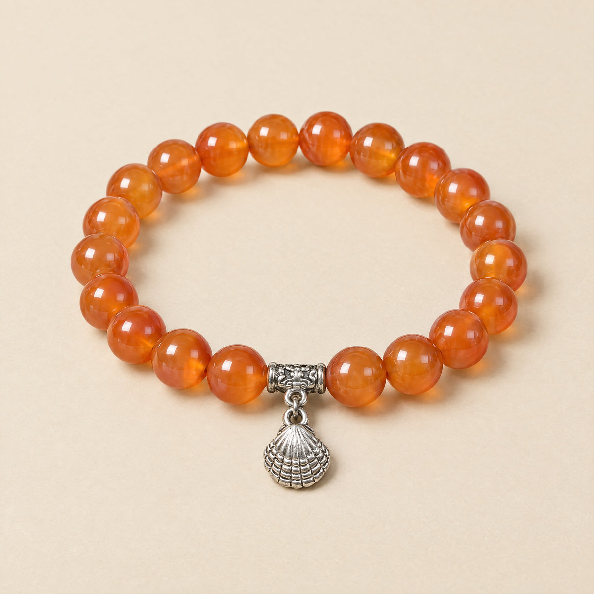 Seashell Charm Bracelet: 8 mm carnelian beads with a silver-tone seashell charm