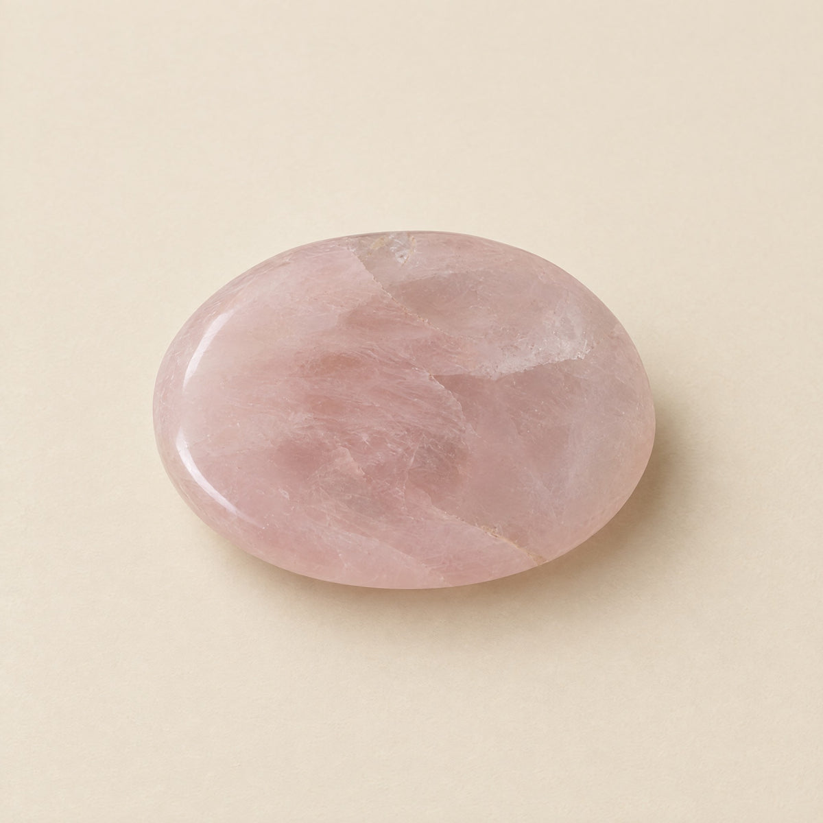 Polished rose quartz worry stone with thumb dip