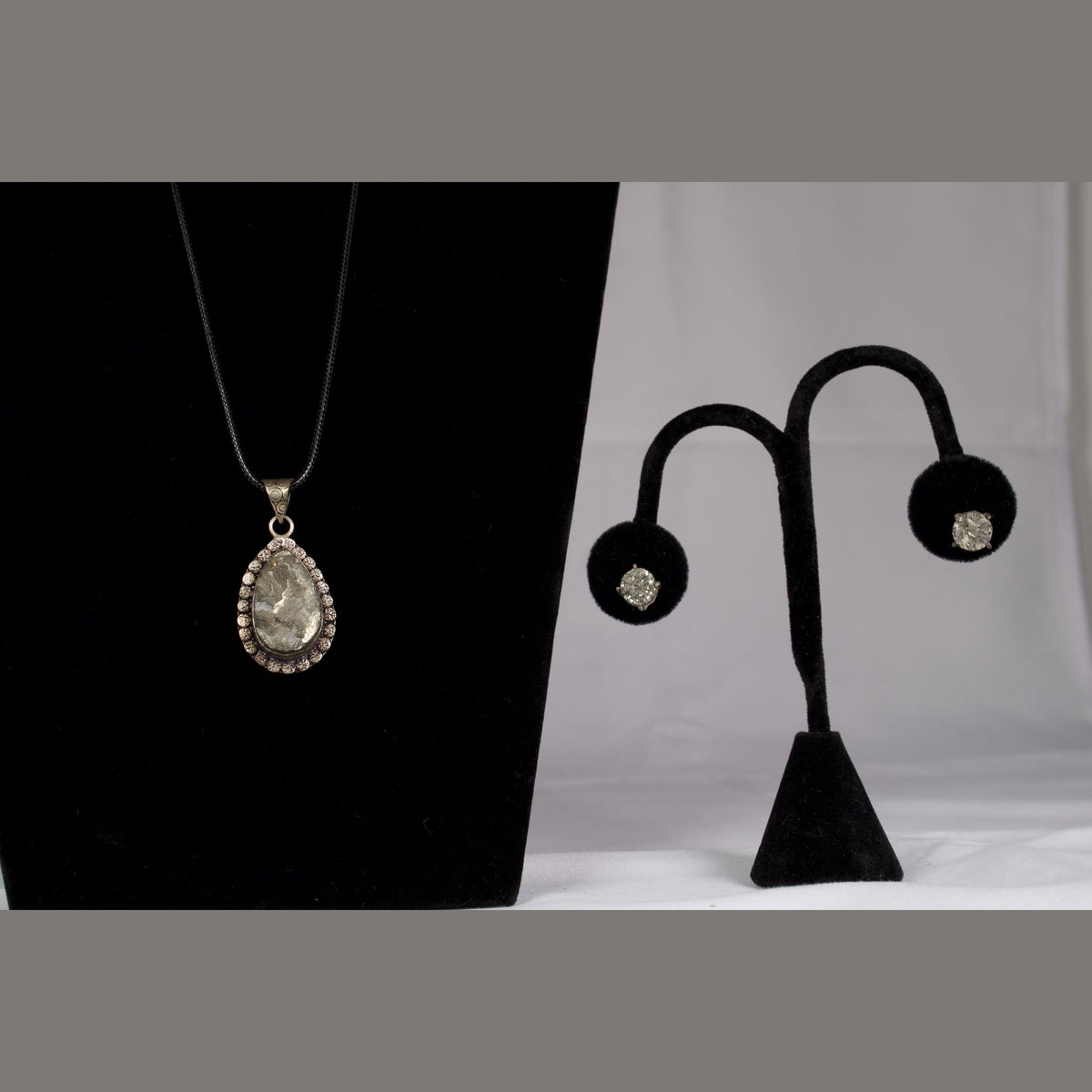Unedited photo of the pyrite pendant and stud earrings together