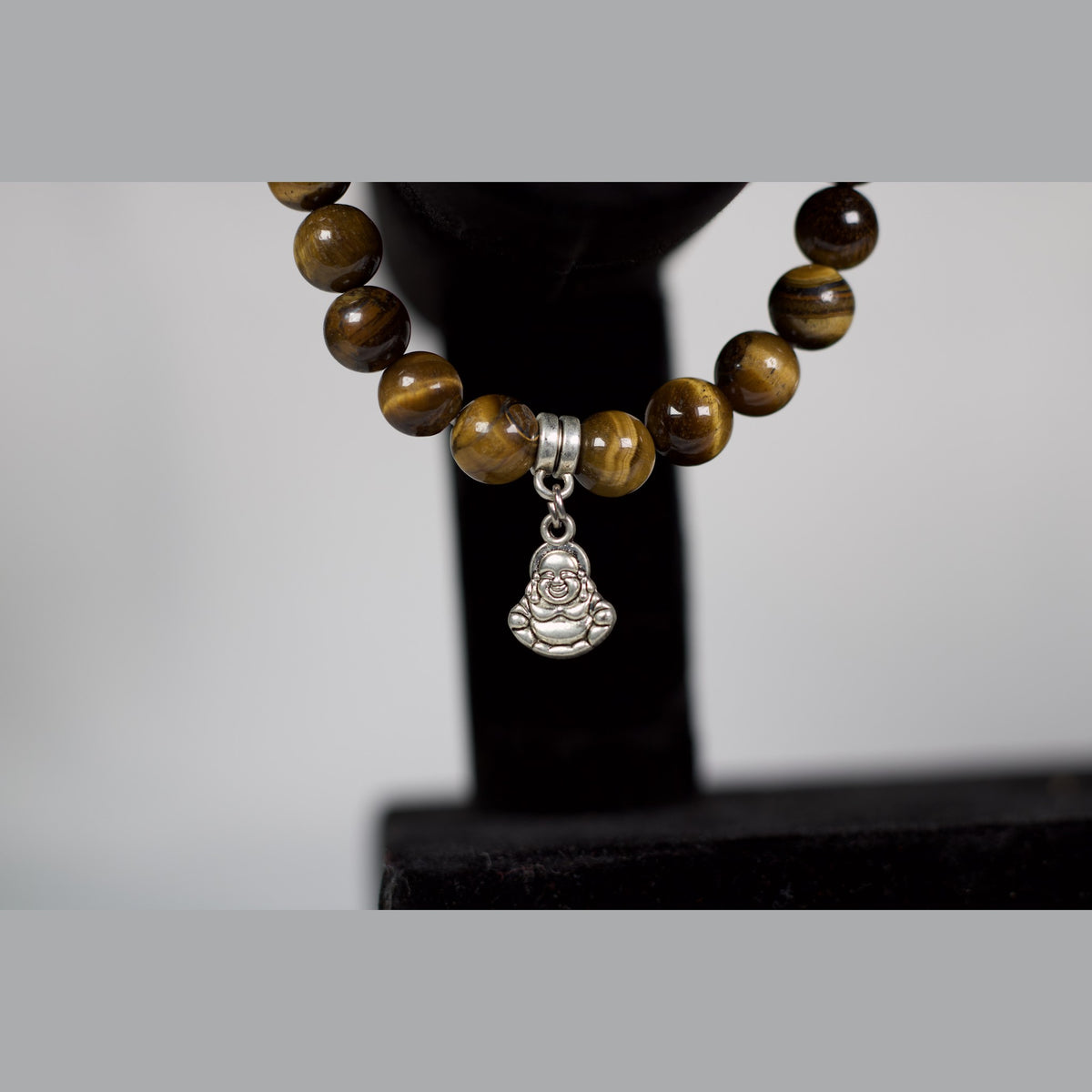 Unedited close-up of the Laughing Buddha charm
