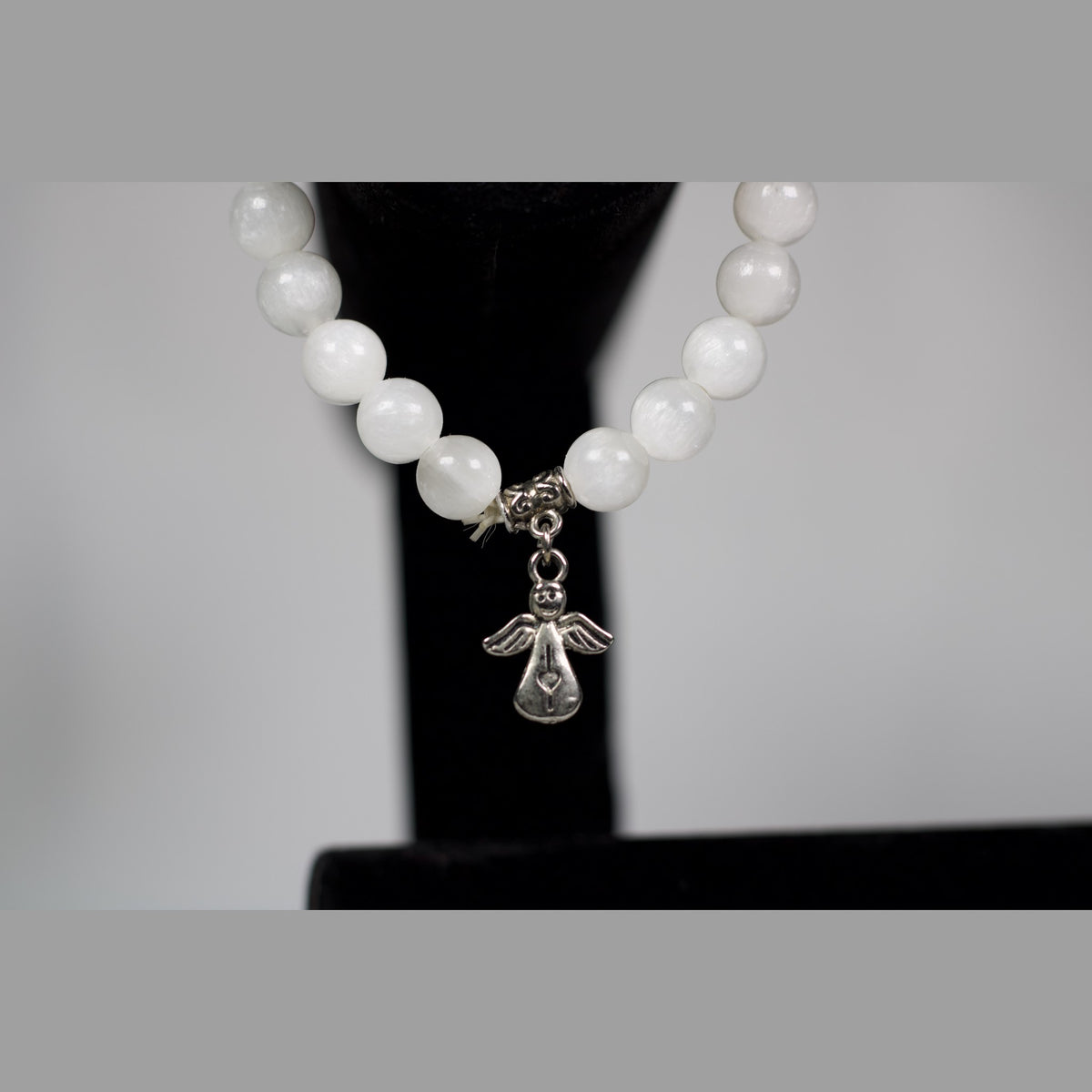 Unedited close-up of the guardian angel charm