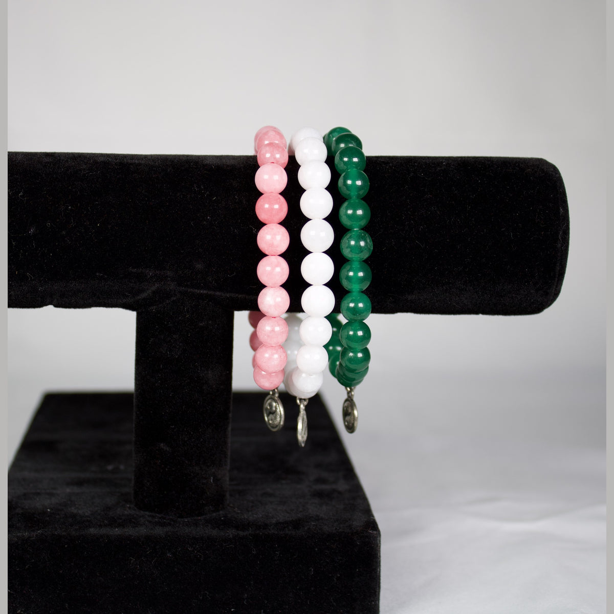 Unedited photo of the yin yang bracelets in stock: pink, white and green