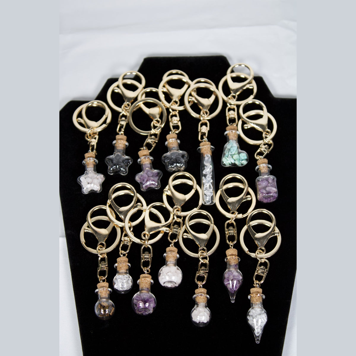 Unedited photo of all 14 wish bottle keychains in stock