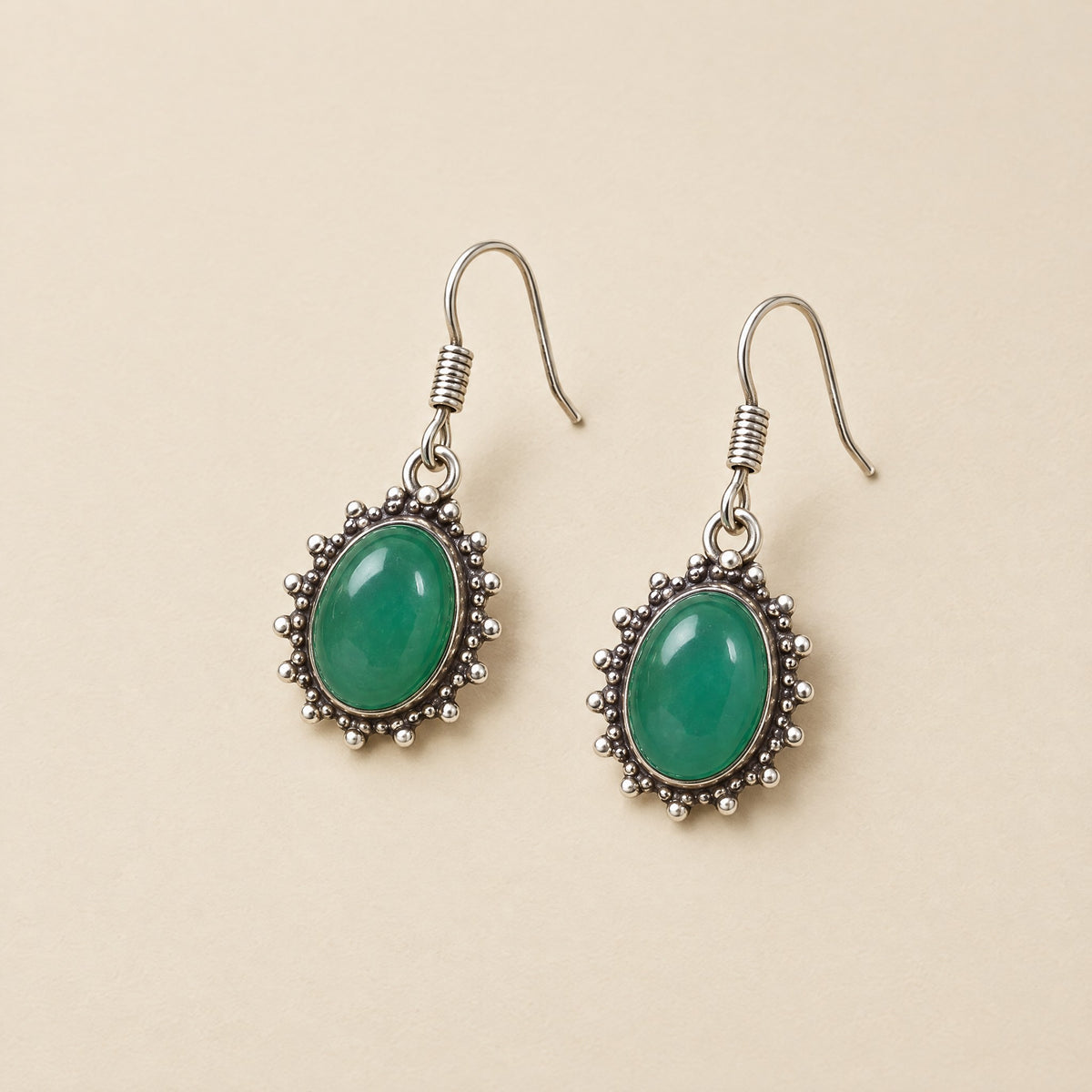 Green onyx oval drop earrings in beaded silver-tone frames
