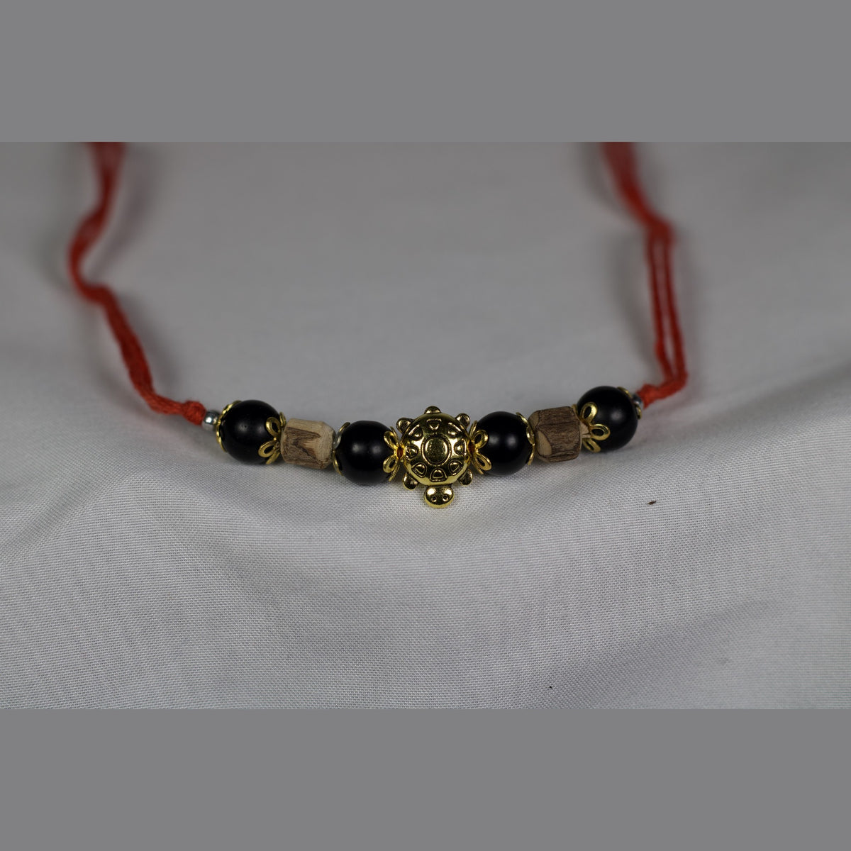 Unedited front photo of the red string bracelet