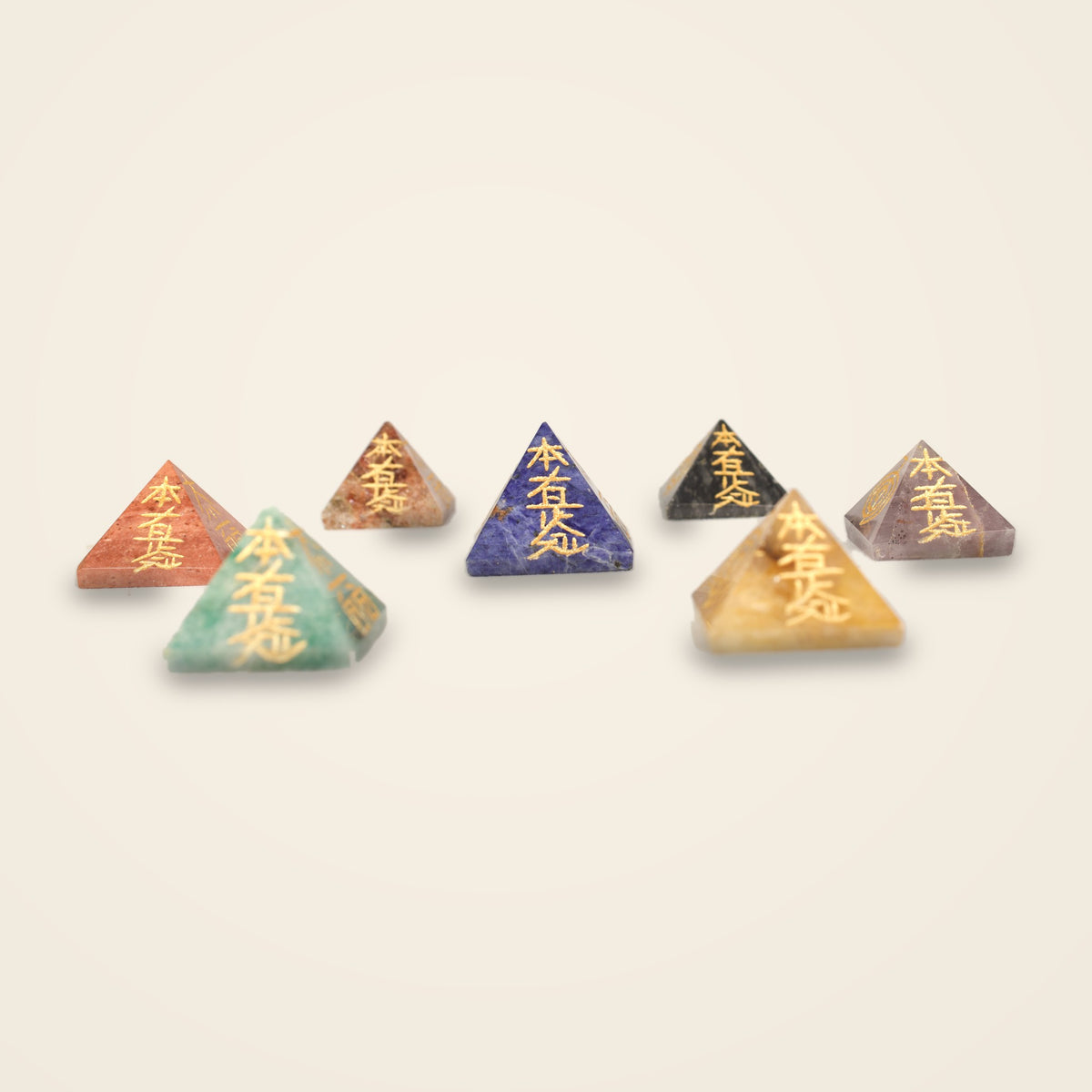 Set of 7 small crystal pyramids engraved with gold-tone Reiki symbols
